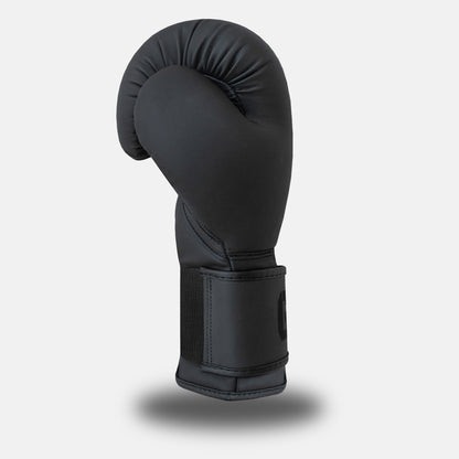 Side profile of GSX Black on black boxing glove featuring smooth contour padding and a reinforced wrist strap
