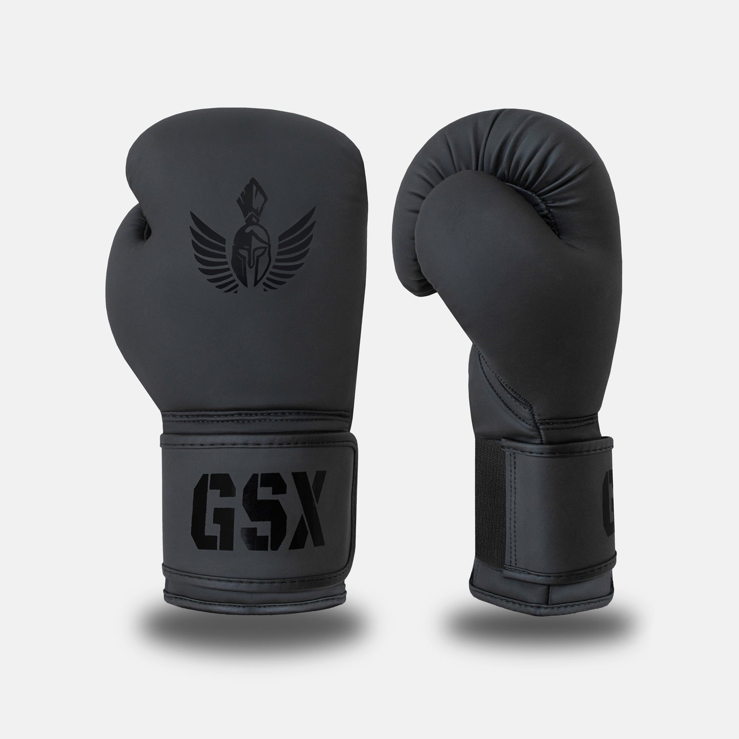 Front and side view of GSX black-on-black boxing gloves with matte finish and tonal Spartan logo detailing.