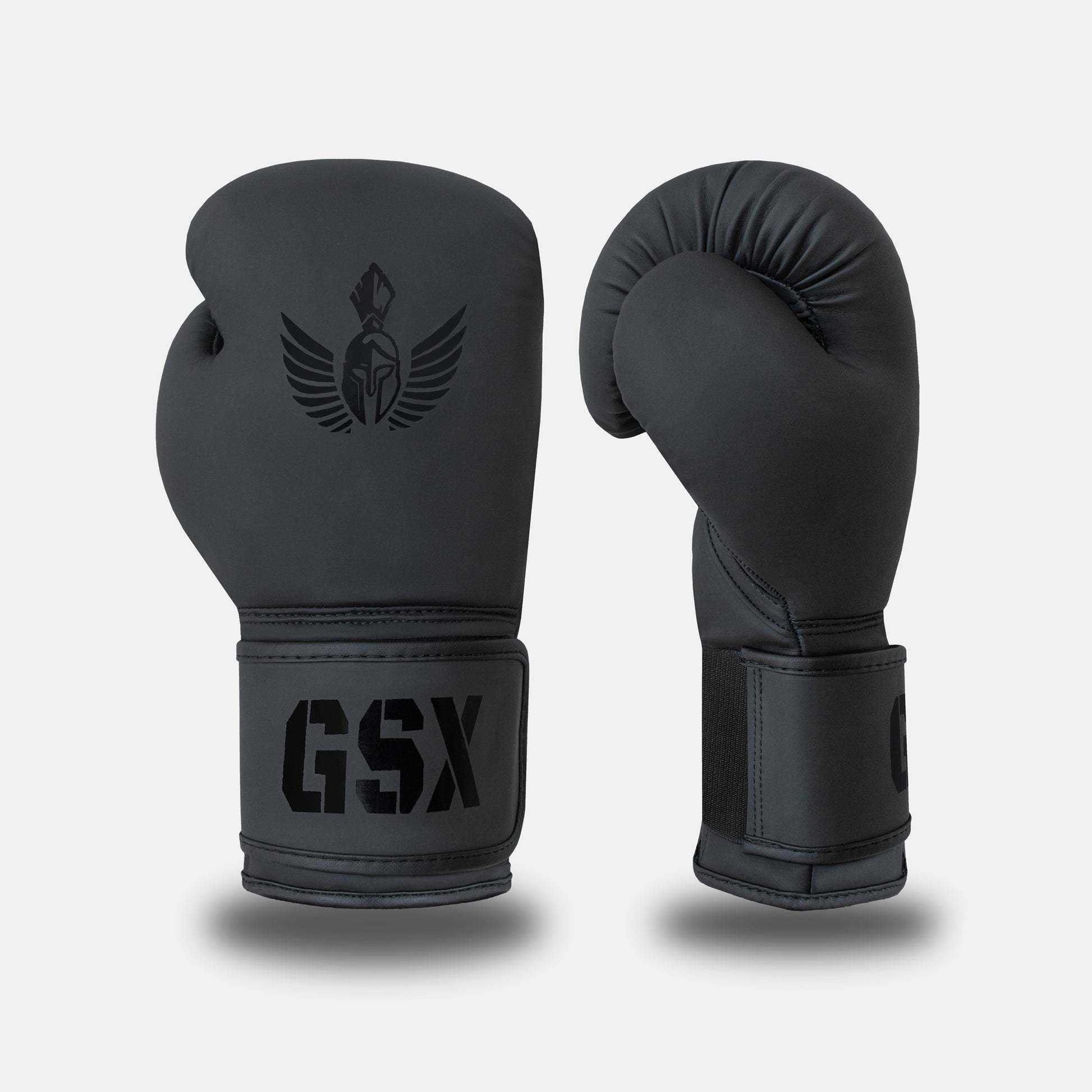 Front and side view of GSX black-on-black boxing gloves with matte finish and tonal Spartan logo detailing.