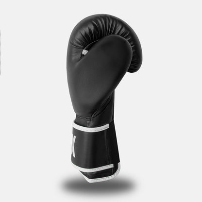 Side view of a white-on-black GSX boxing glove showing the curved padding and wrist strap design.
