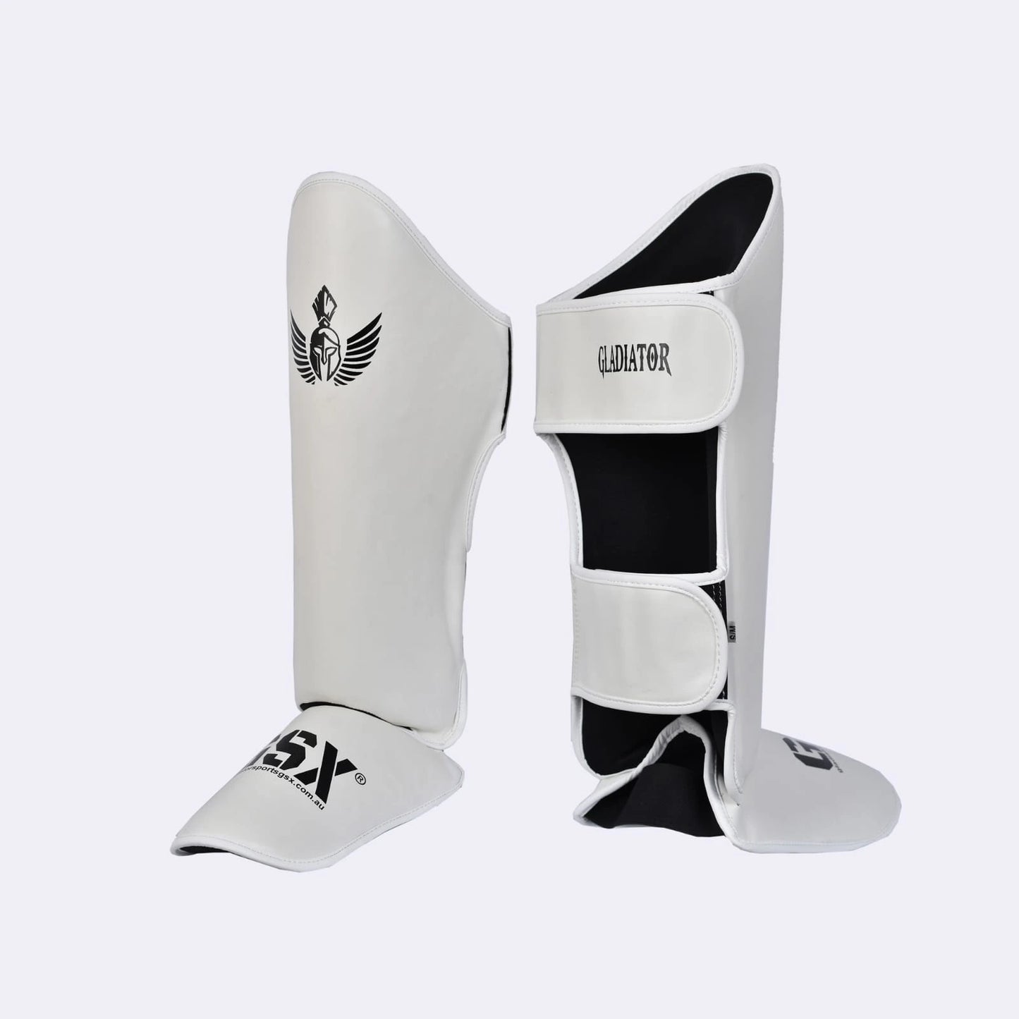 Angled view of white Gladiator GSX shin guards, highlighting instep protection and velcro straps.