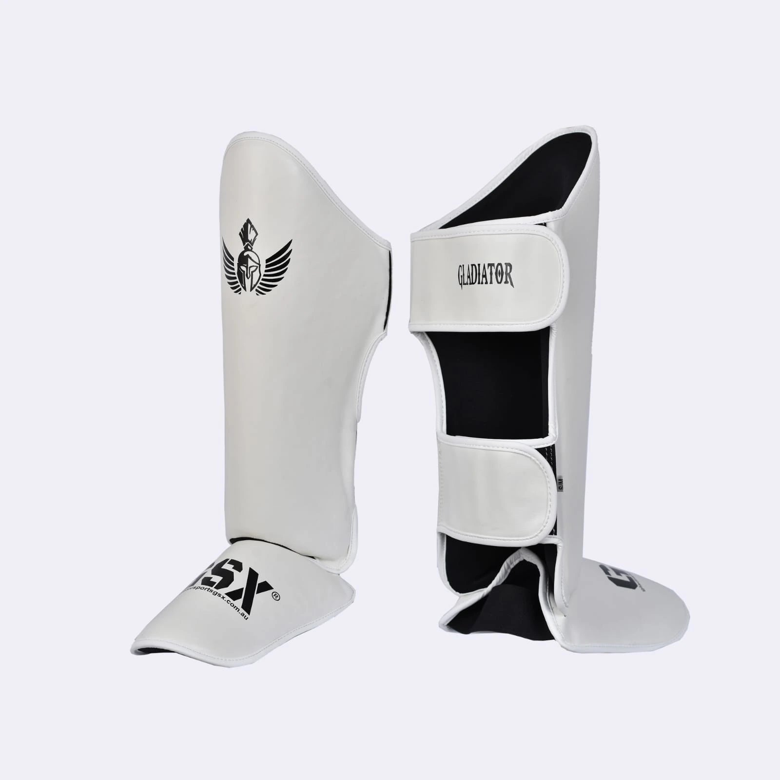 Angled view of white Gladiator GSX shin guards, highlighting instep protection and velcro straps.