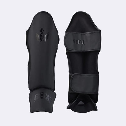 Professional black Gladiator shin guards with GSX branding, designed for combat sports and martial arts training.