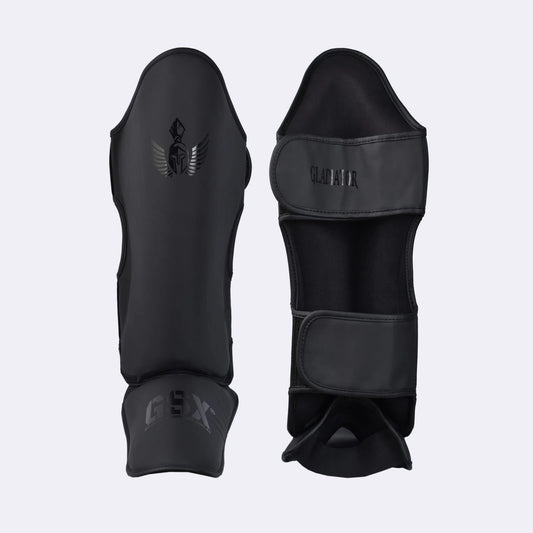 Professional black Gladiator shin guards with GSX branding, designed for combat sports and martial arts training.